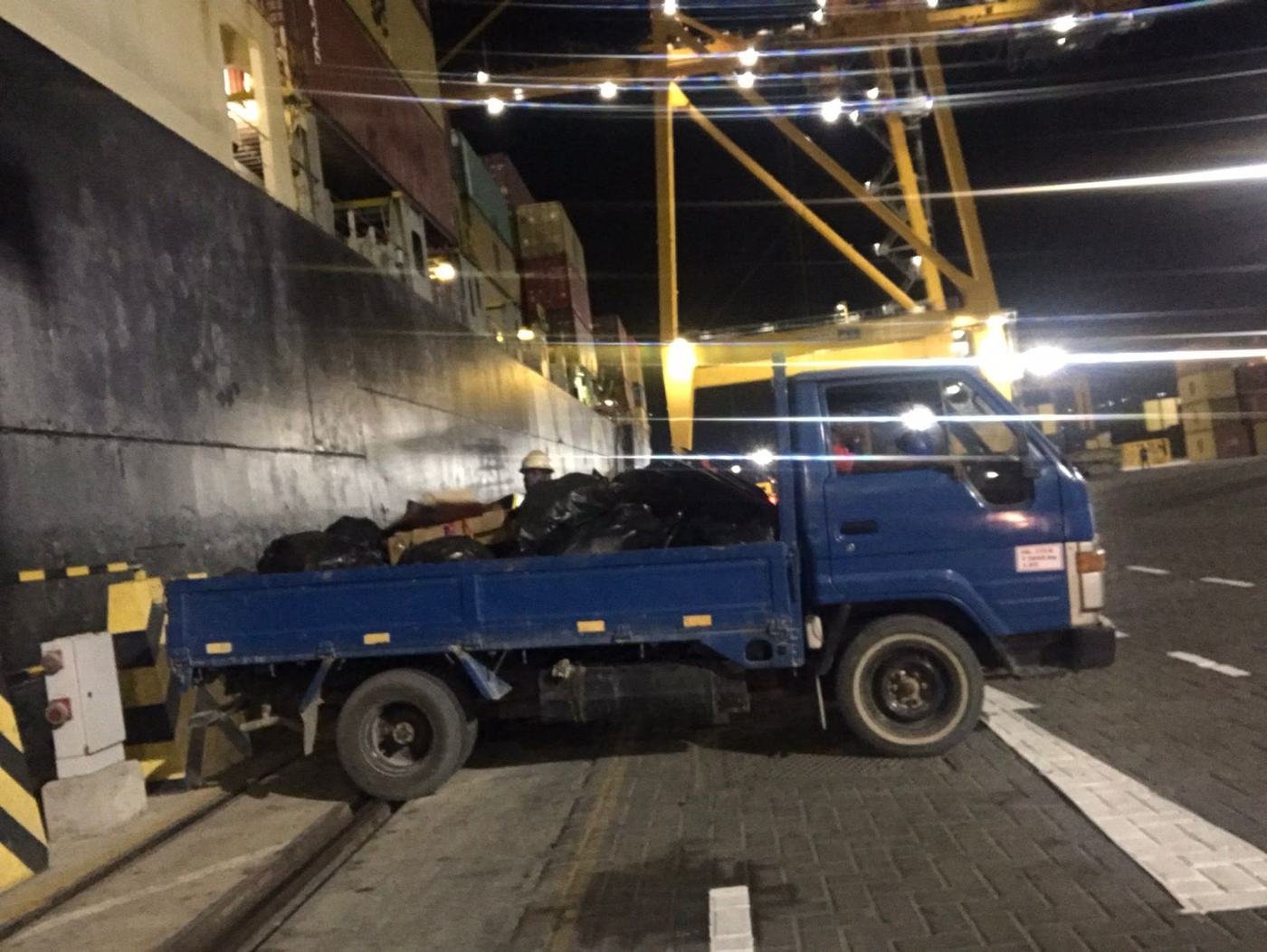 Tila truck alongside a ship at night