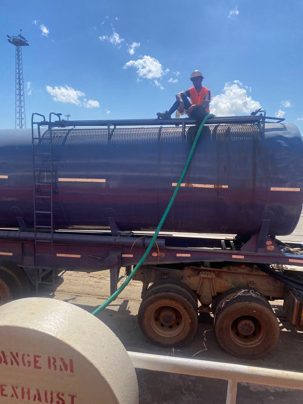 Technician on top of a water tanker