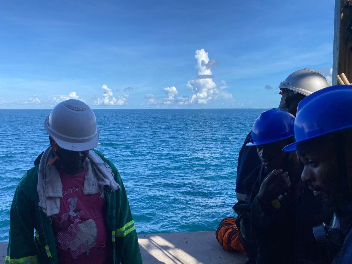 Tila crew on an operation at sea, wearing hard hats and hi-vis vests