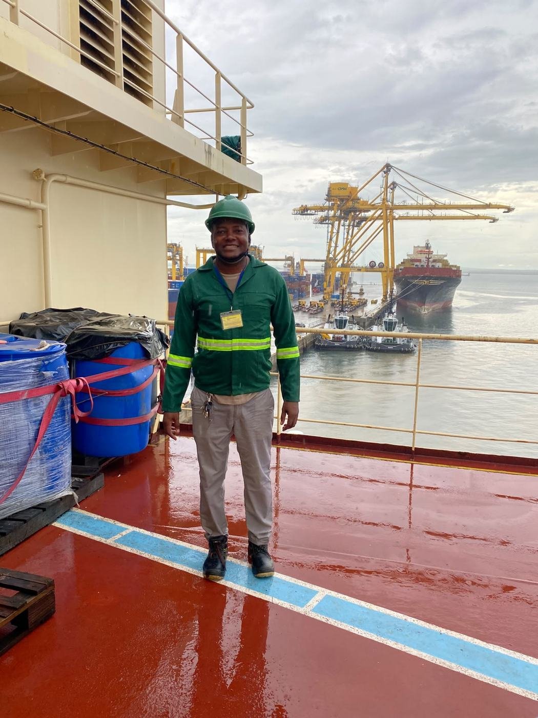 Technician on deck with cranes behind